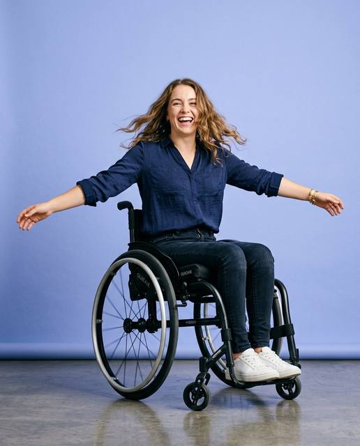 Woman spinning joyfully in her wheelchair