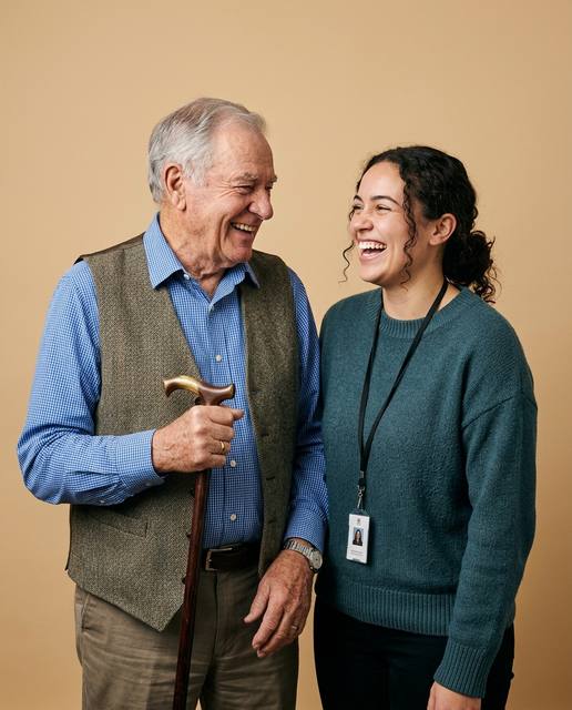 Older man and his support worker sharing a laugh