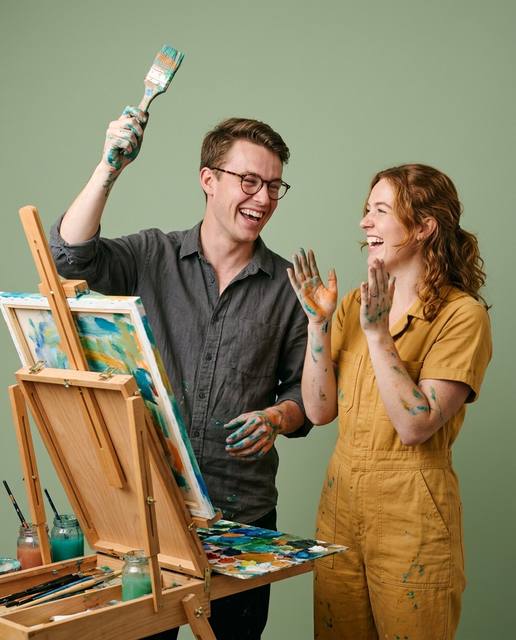 Two friends celebrating while painting together